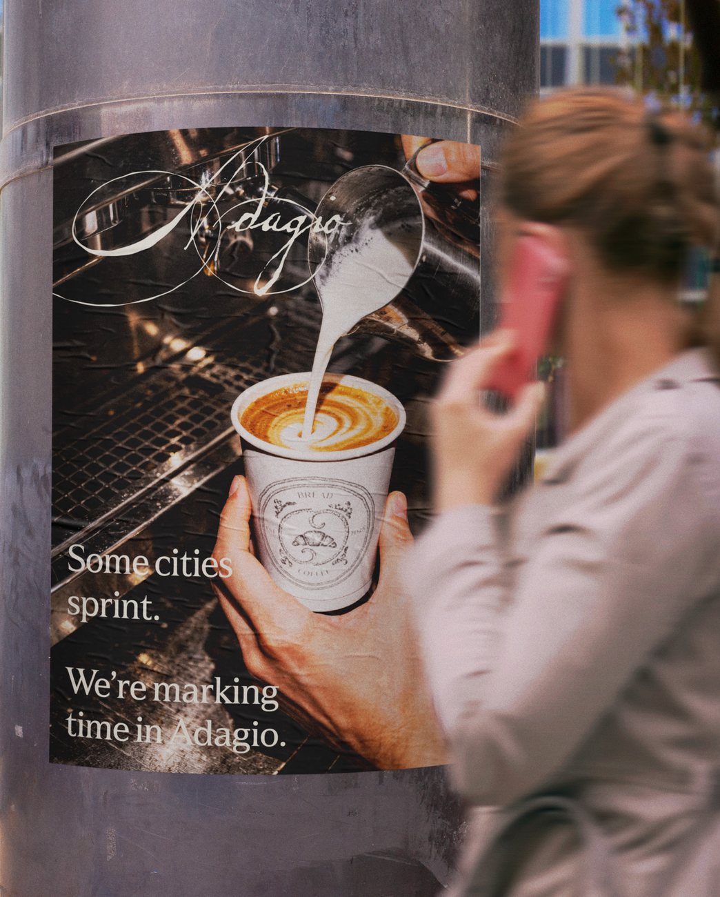 Adagio street poster reading Some cities sprint. We are marking time in Adagio.